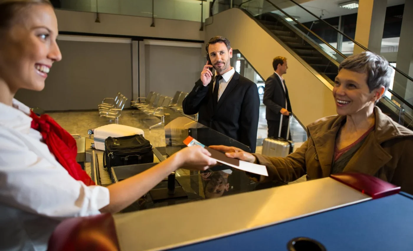 female-staff-giving-boarding-pass-passenger-1
